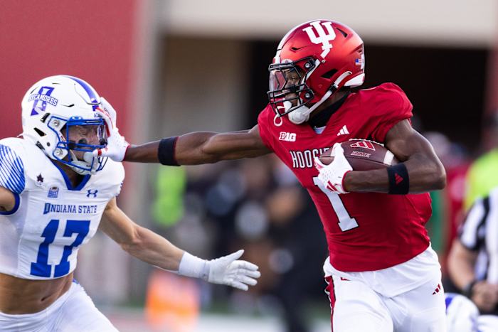 Indiana Hoosiers wide receiver Donaven McCulley (1) stiff arms Indiana State defensive back Maddix Blackwell (17) in the first half at Memorial Stadium.